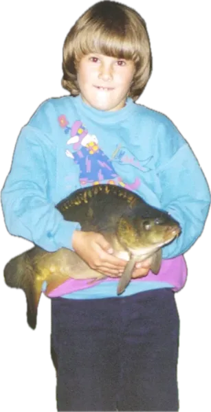 A child holding a fish from the lake